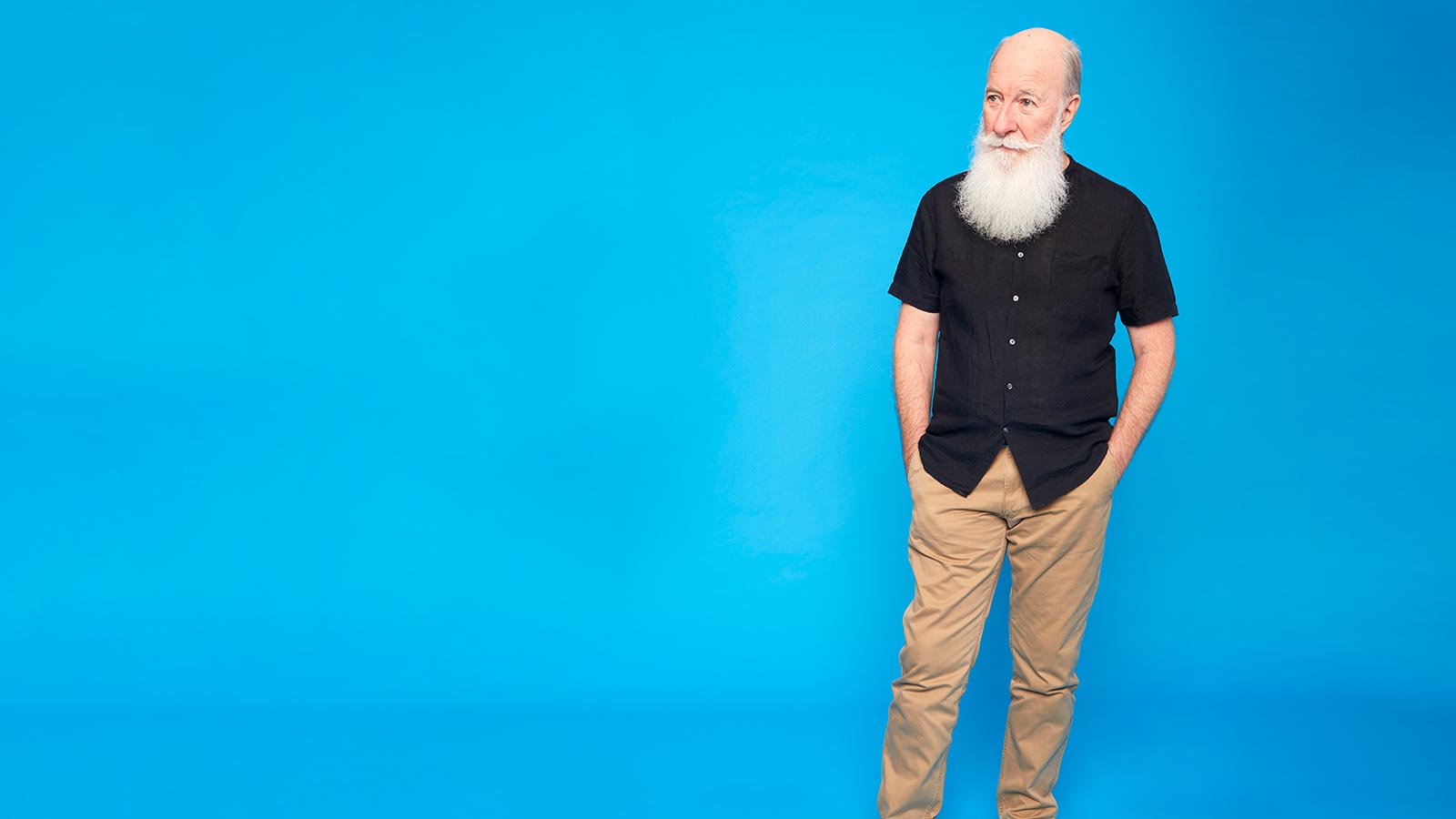 Man standing with his hands in his pockets.