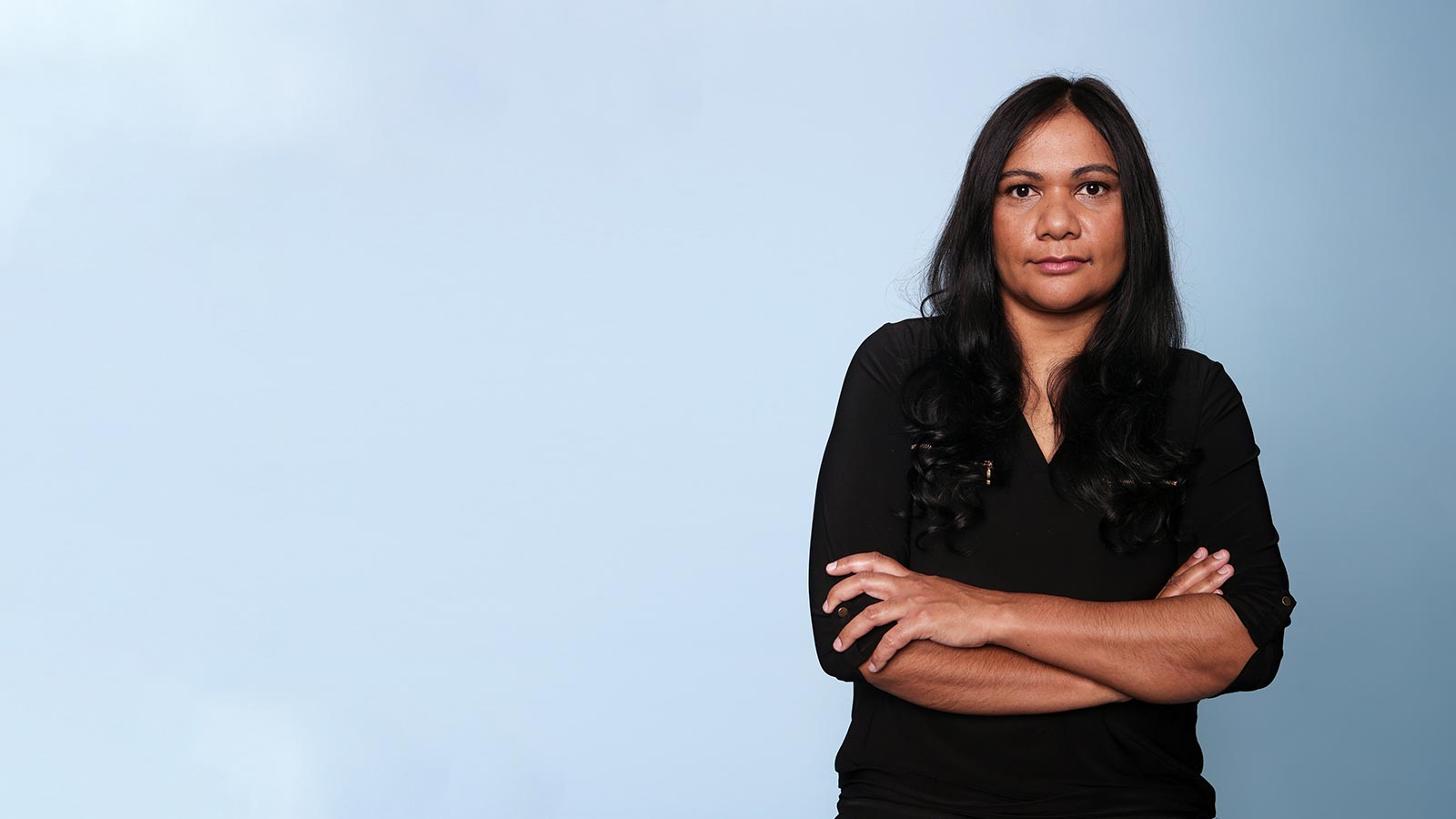Woman standing with her arms crossed.