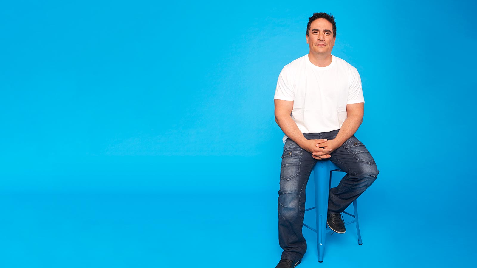 Man sitting on stool.