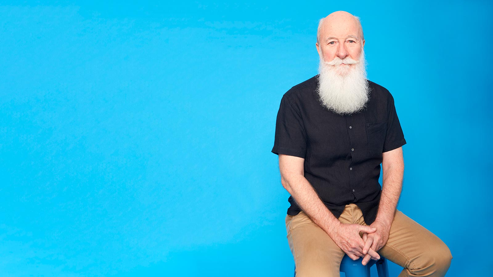 Man sitting on stool.